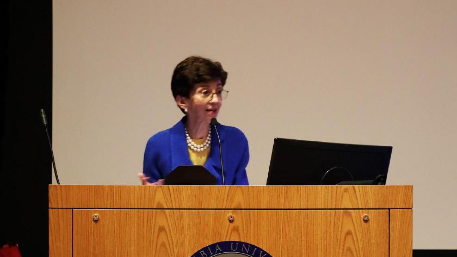 Woman stands at podium