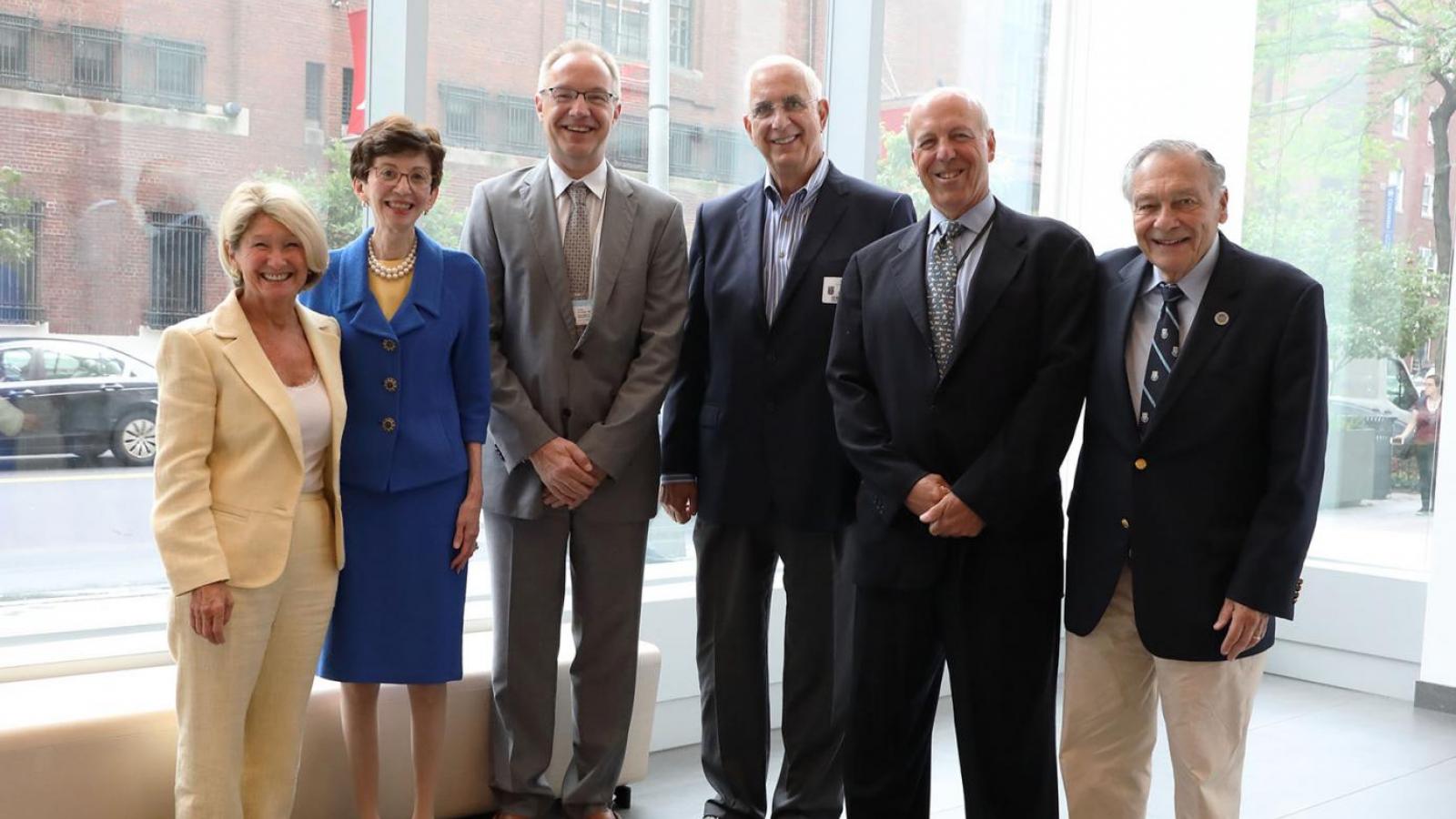 Men and women pose for a group picture