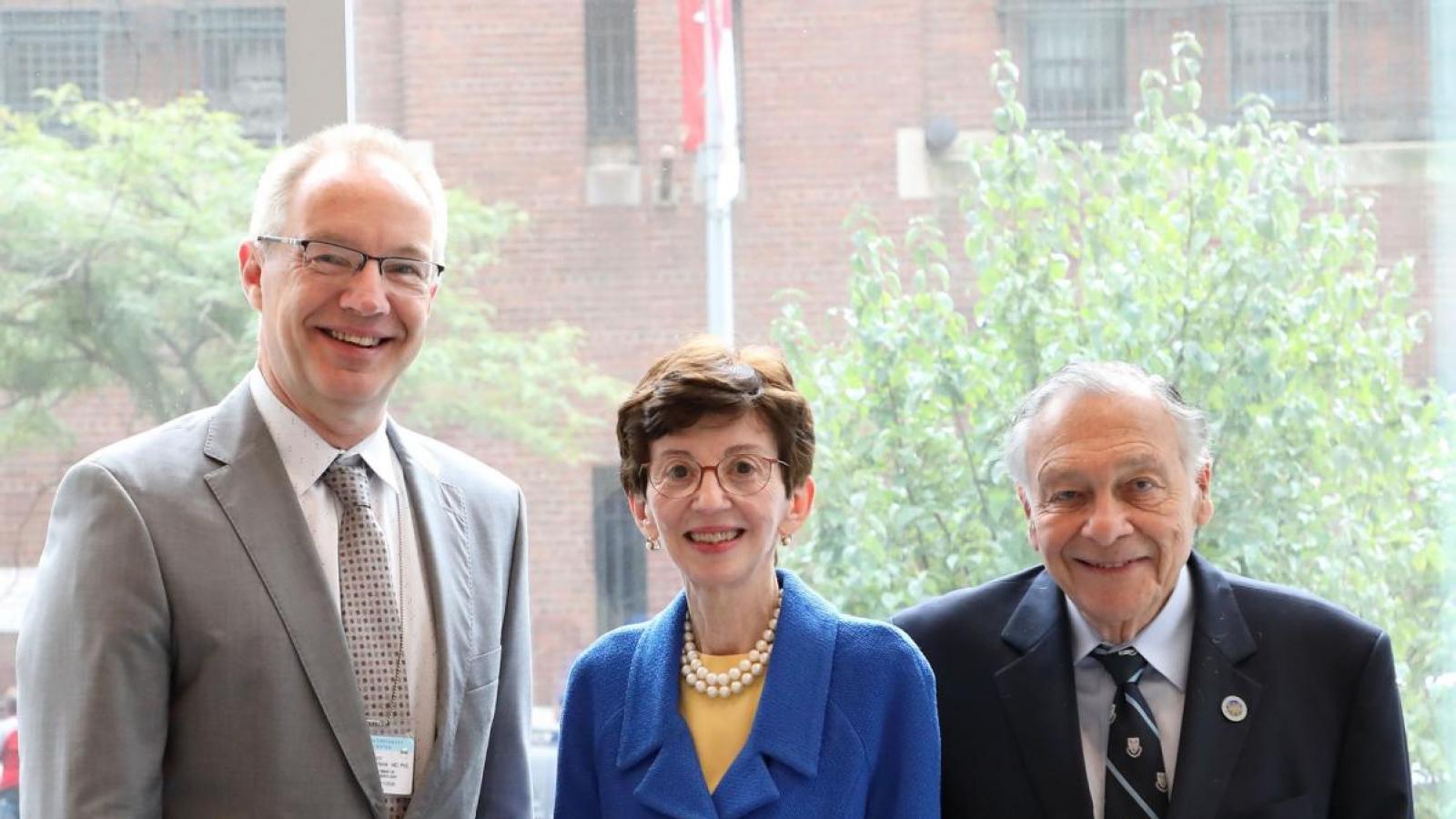 Men and woman pose for picture