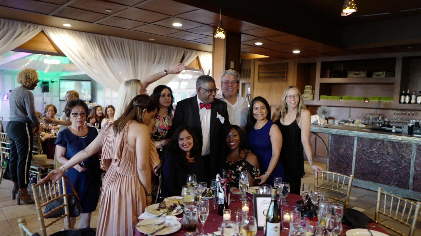 People gathered around table at celebration