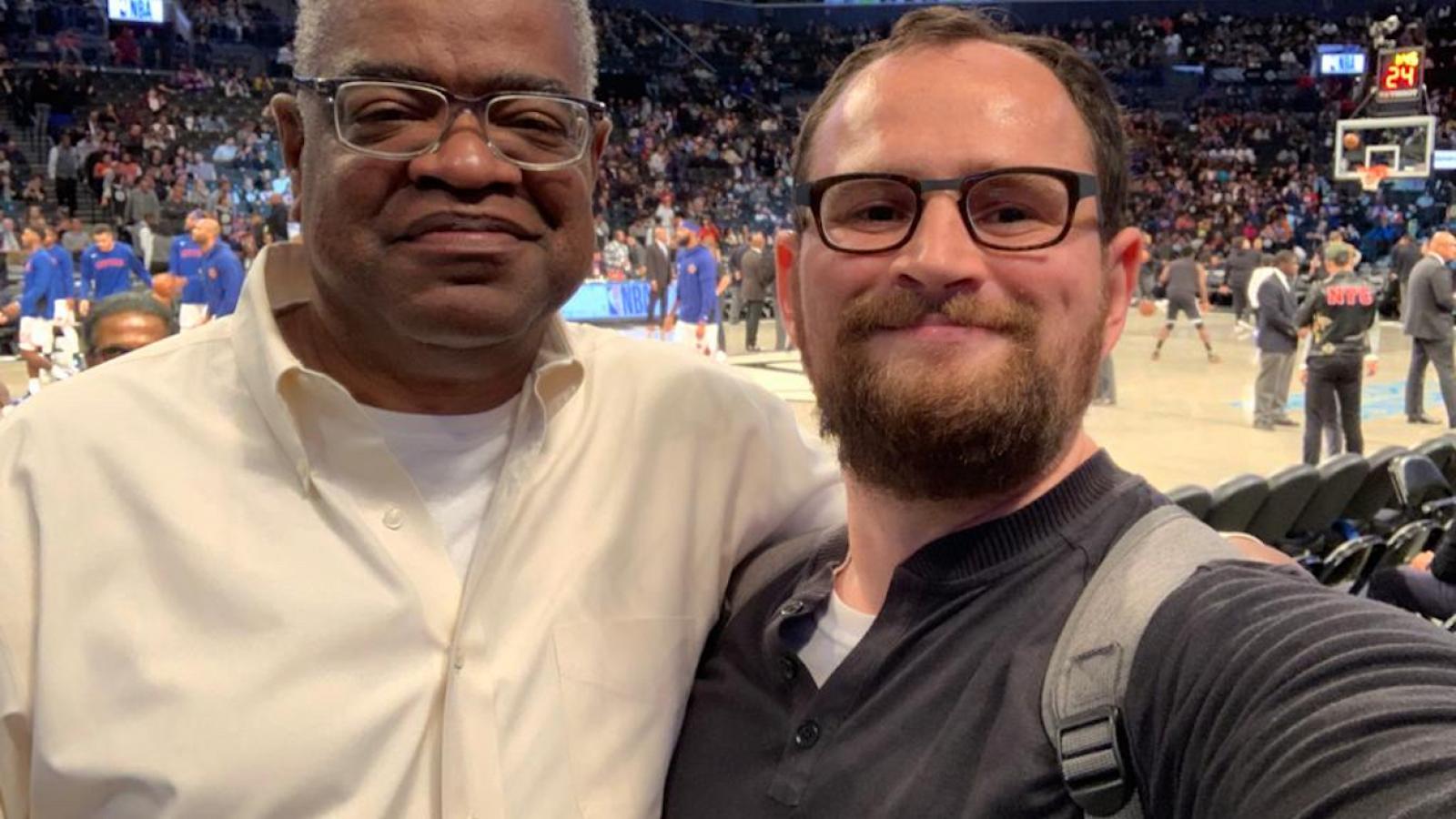 Two men taking selfie at basketball game