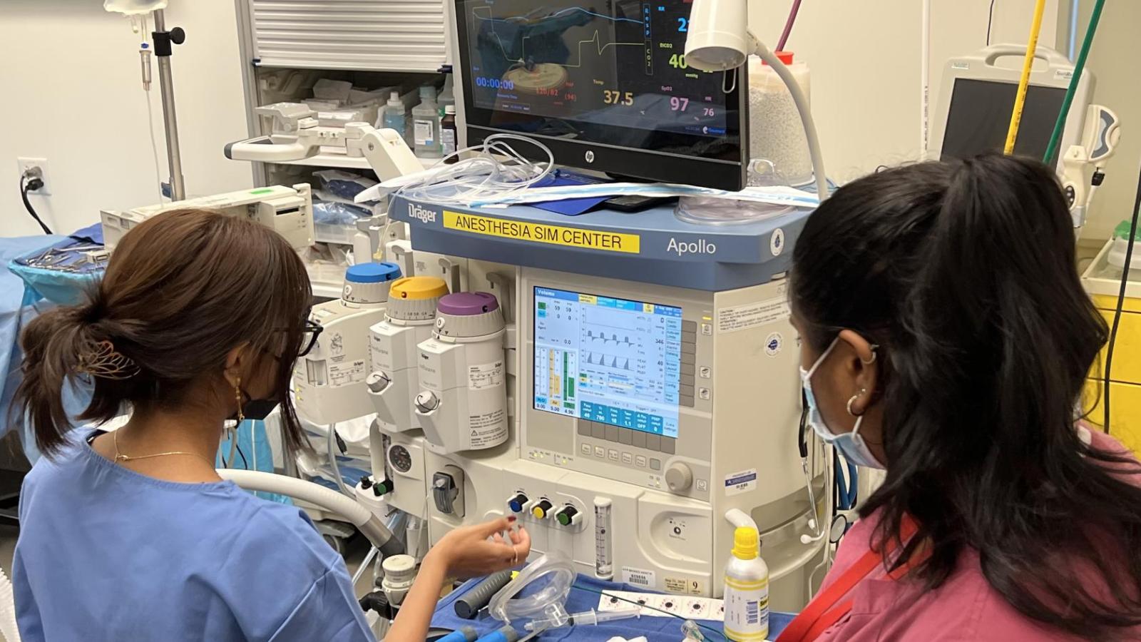 Students learning how to use anesthesia machine