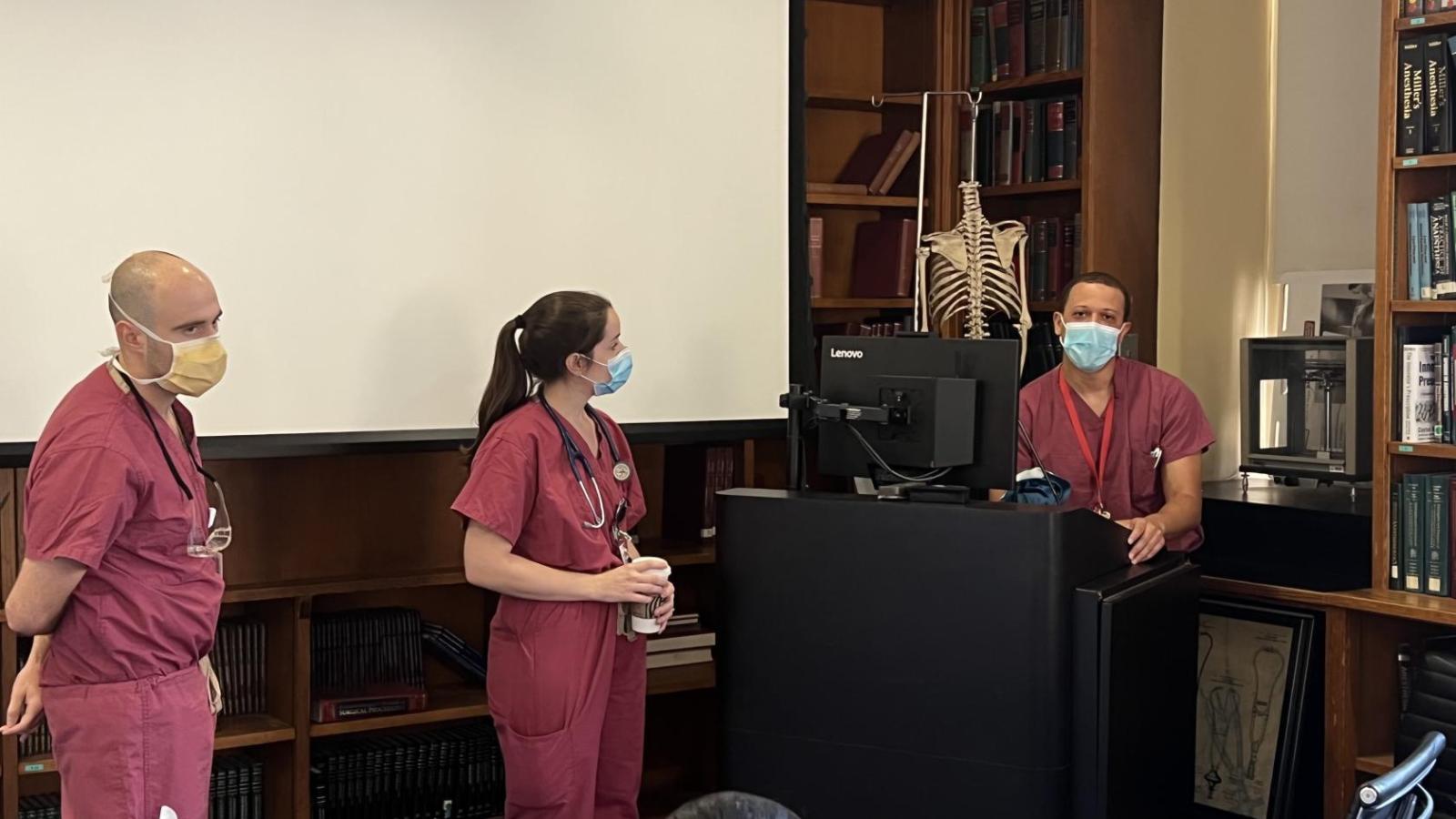 Residents at podium w skeleton model in background