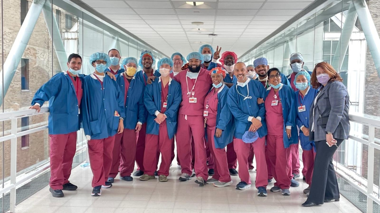 Group of hospital workers posing on interior bridge