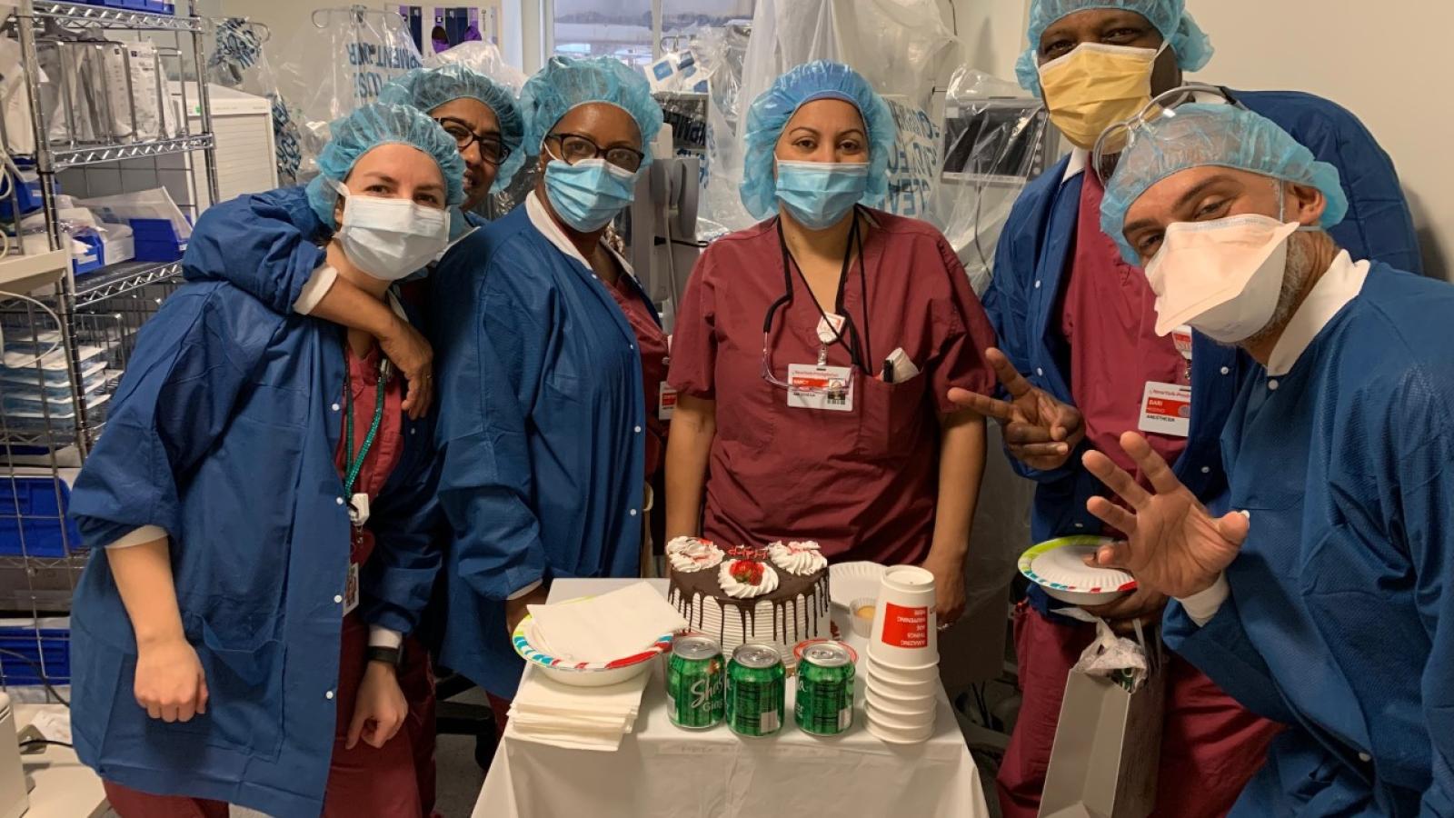 Group of six masked anesthesia techs preparing supplies