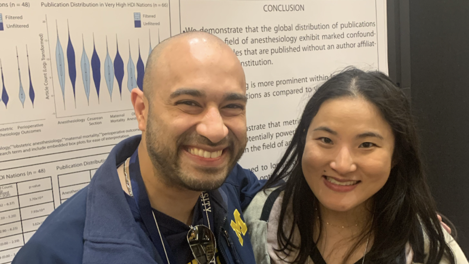 Woman and man standing in front of scientific poster