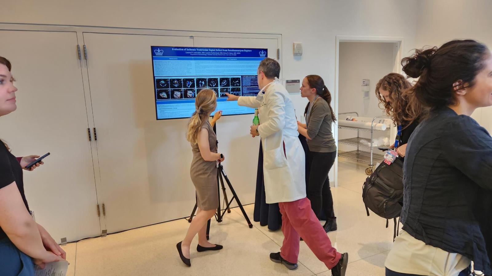 People discussing scientific poster