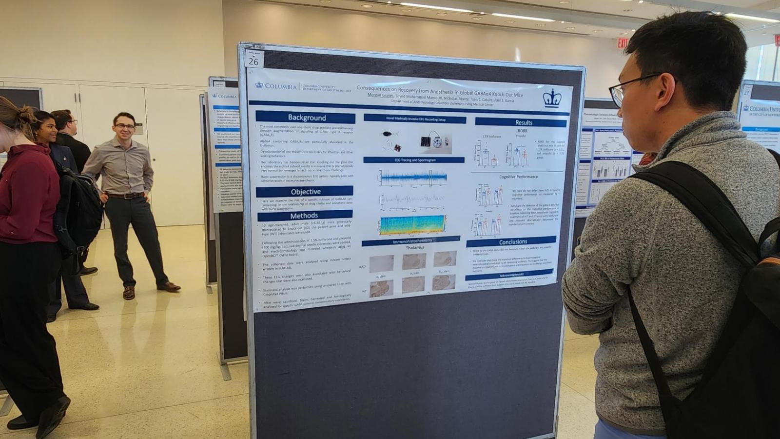 Man looking at poster at conference