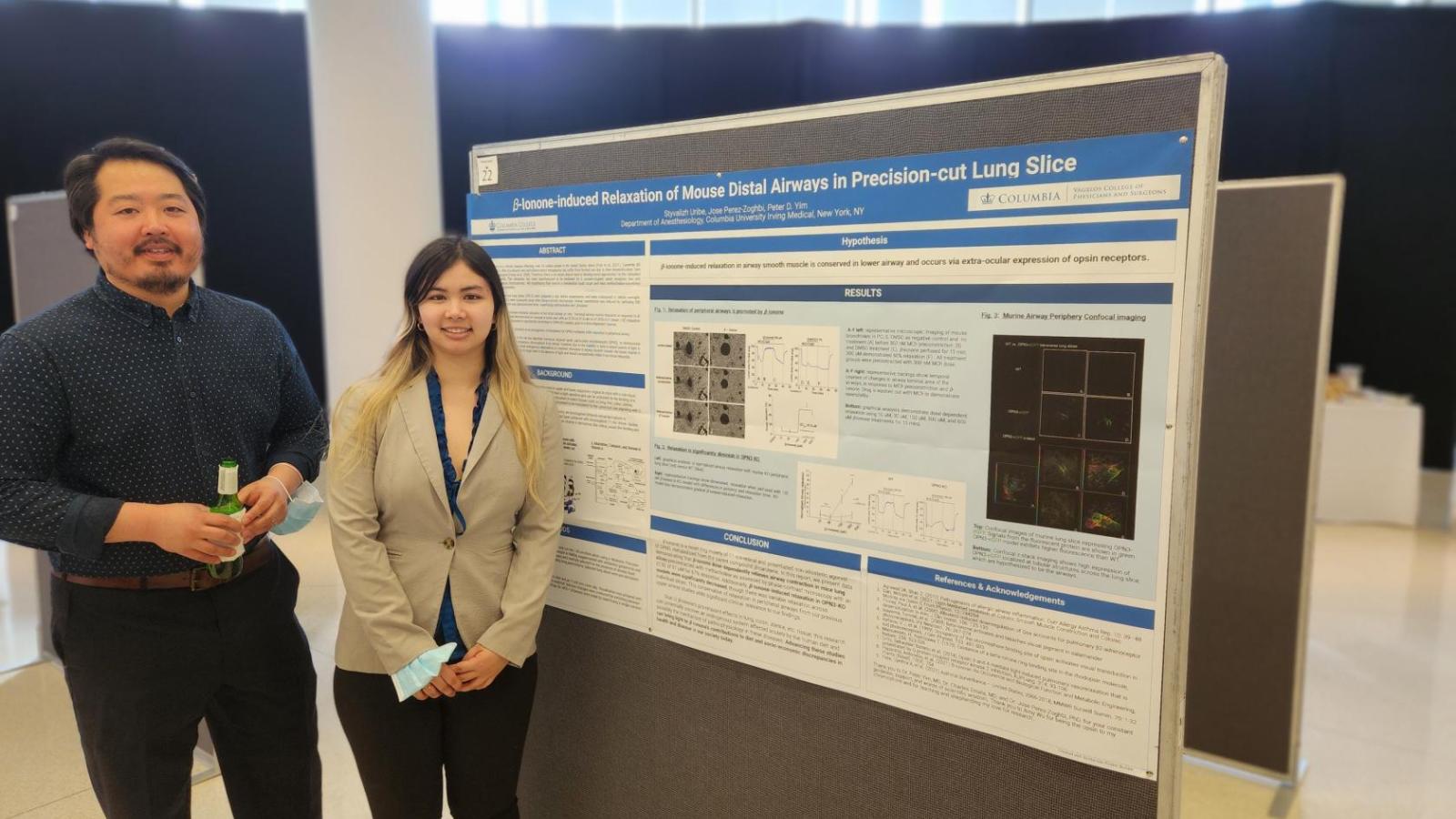 Woman and man standing in front of scientific poster