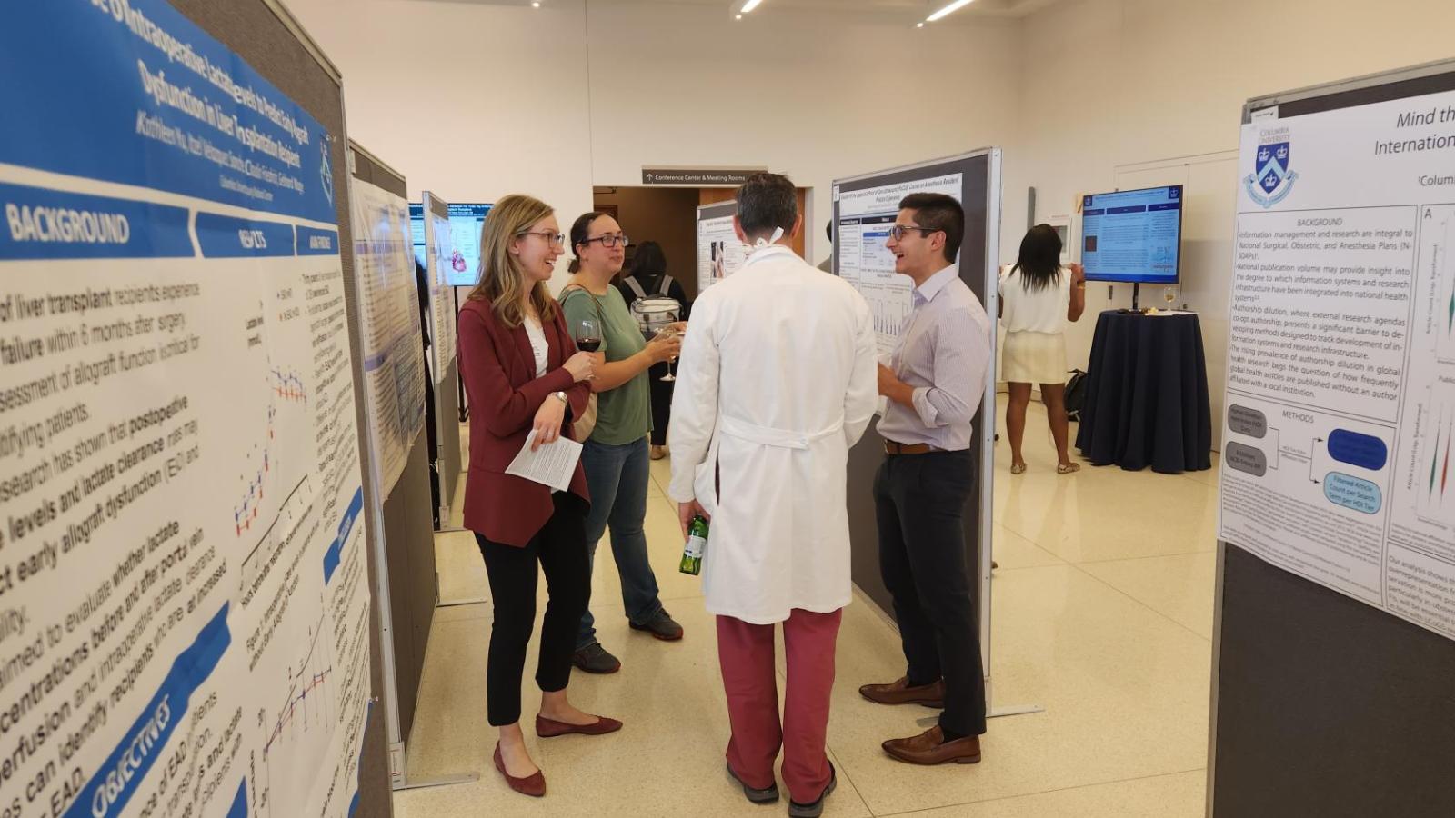 People discussing scientific poster