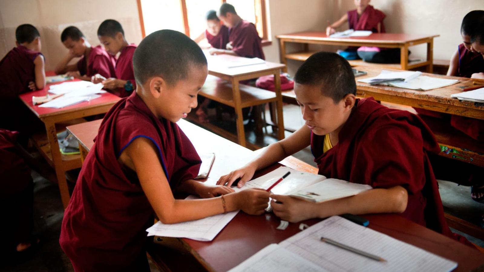 Like students everywhere, young monks work together during their lessons.