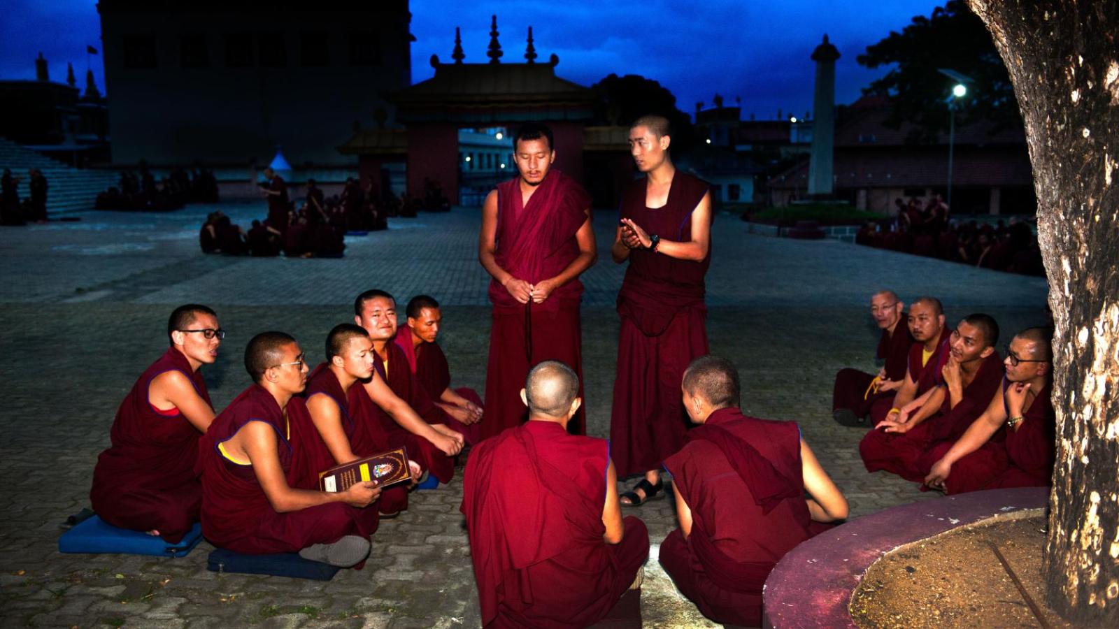 challengers and defenders debate one another against the backdrop of the darkening sky
