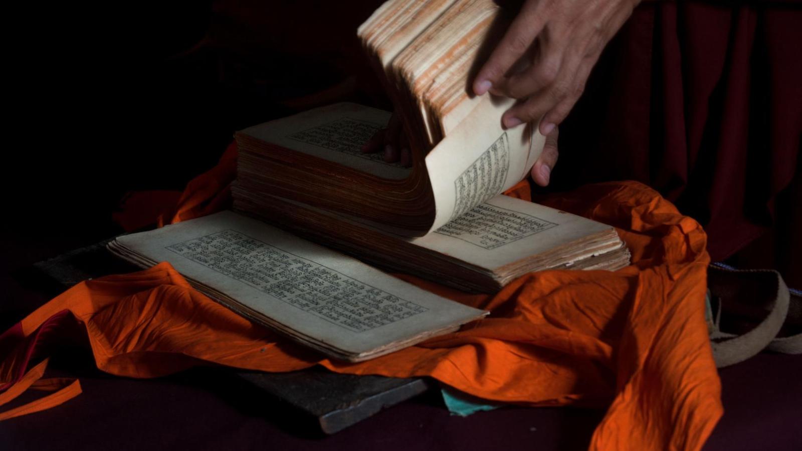 Tibetan Buddhist scriptures are unbound oblong pages with tibetan text writing across the long side of the pages.