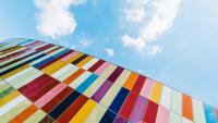 Colorful rectangles against blue sky with clouds