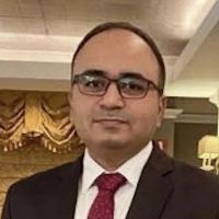 Man with glasses, suit and red tie